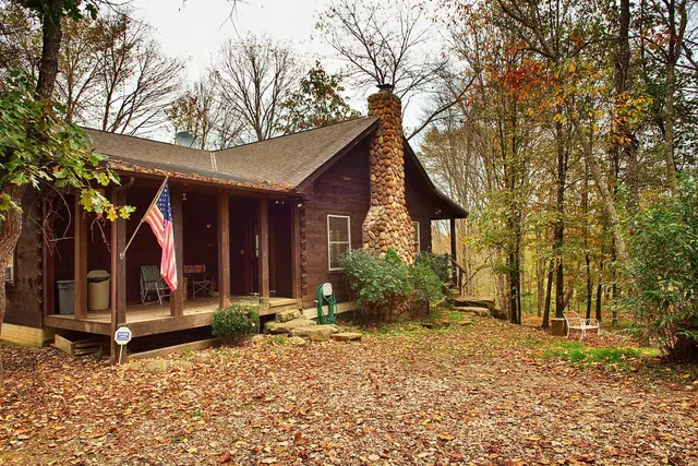 Cabin front porch with fall leaves covering the yard