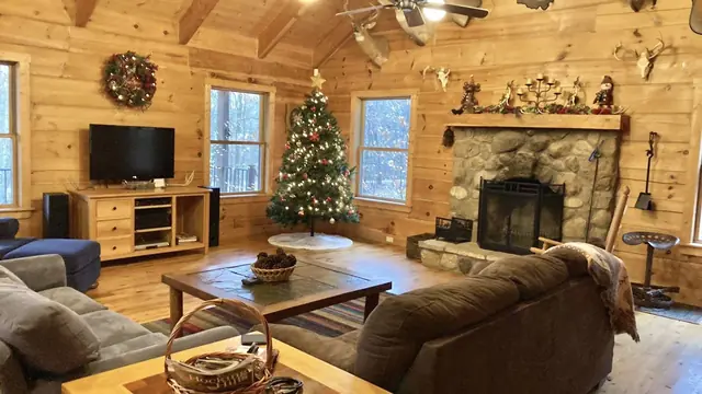 Great room decorated for Christmas with a tree and wreath