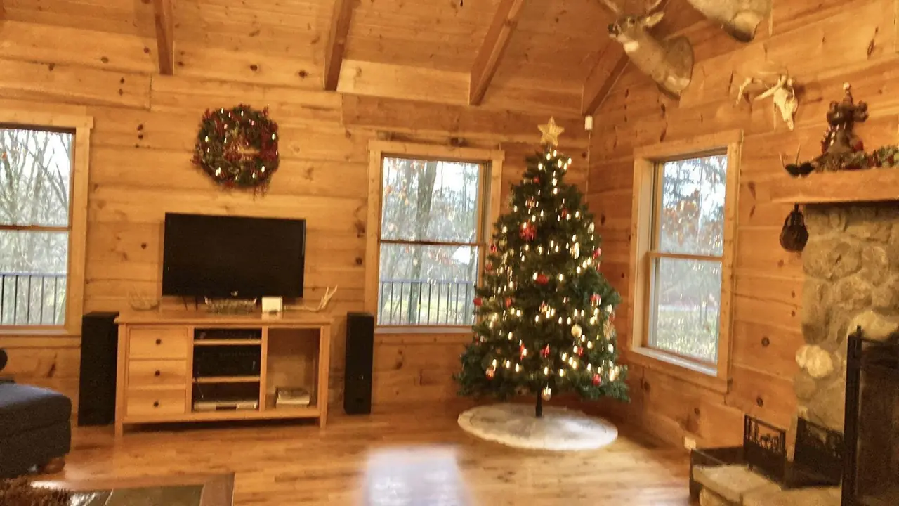 Christmas tree glowing in the great room of Serenity Lodge