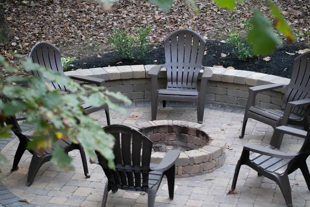 Fire pit patio with a curved stone seating wall