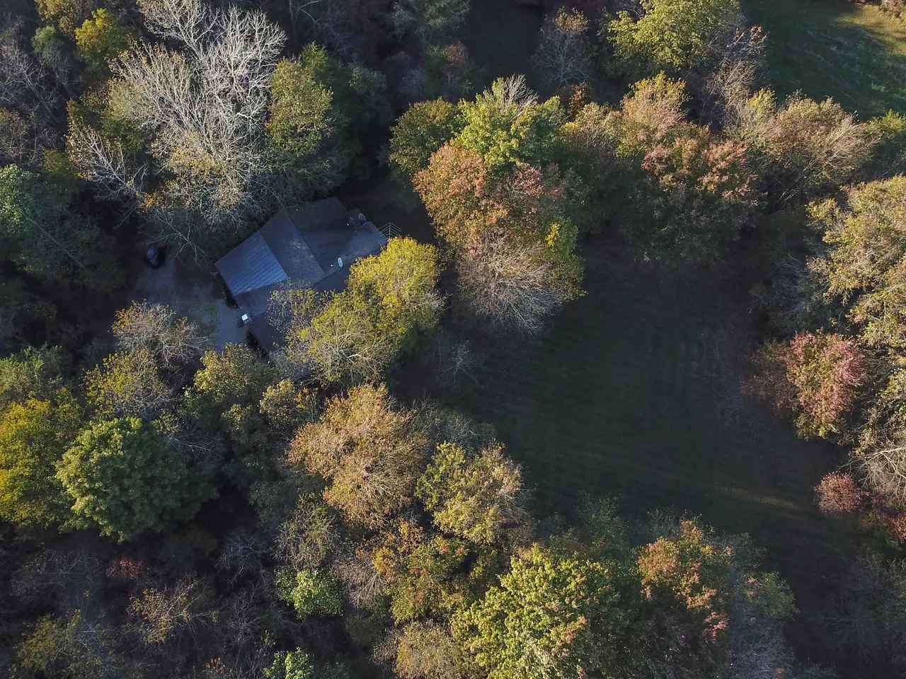 Aerial view of Serenity Lodge tucked into the trees on 97 private acres in Hocking Hills