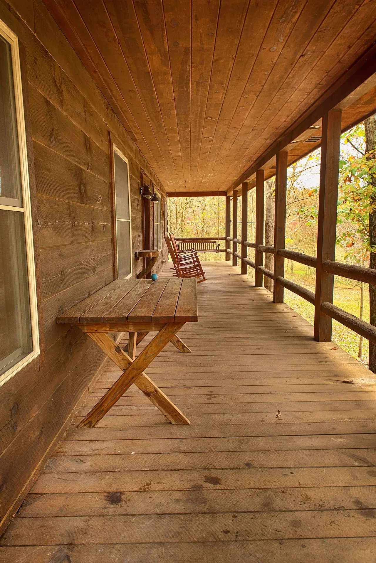 Long covered porch with a handmade table