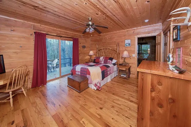 Master bedroom with log walls and handmade furniture