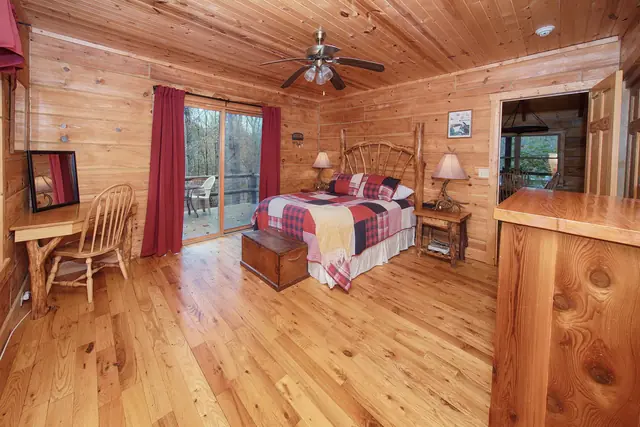 Master bedroom with a queen bed and sliding door to the deck