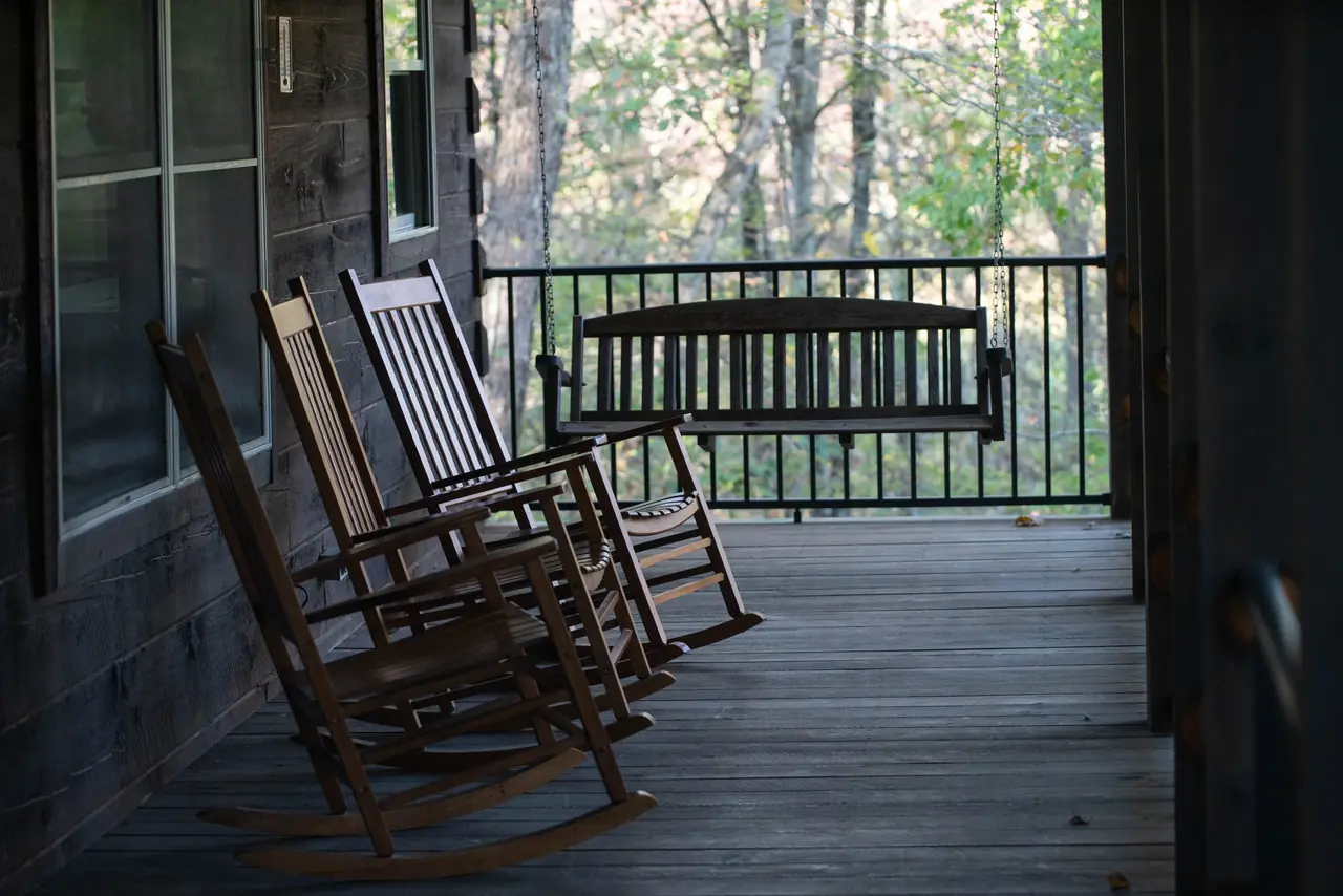 Covered porch with rocking chairs and a porch swing