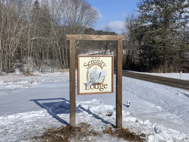 Serenity Lodge sign on a bright winter day